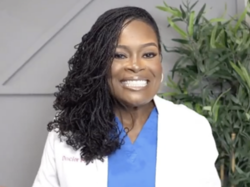 Dr. Kerry-Anne Perkins smiling in white lab coat